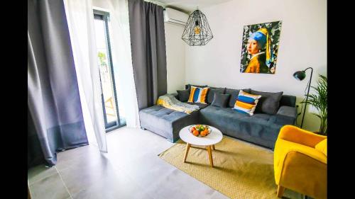 a living room with a blue couch and a table at Holiday home Velebit in Nin