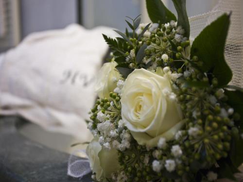 a bouquet of white roses sitting on a table at Hotel Vittoria in Pesaro