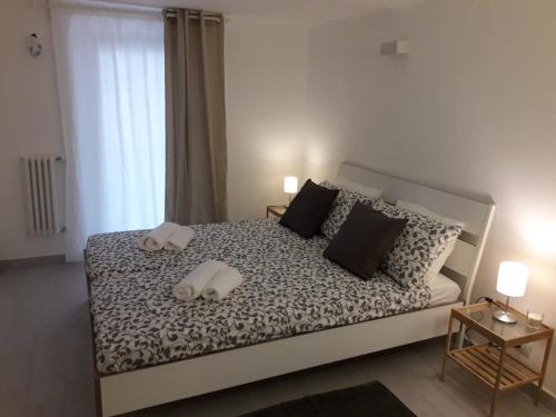 a bedroom with a large bed with two white pillows at Brau&Frau in Taranto