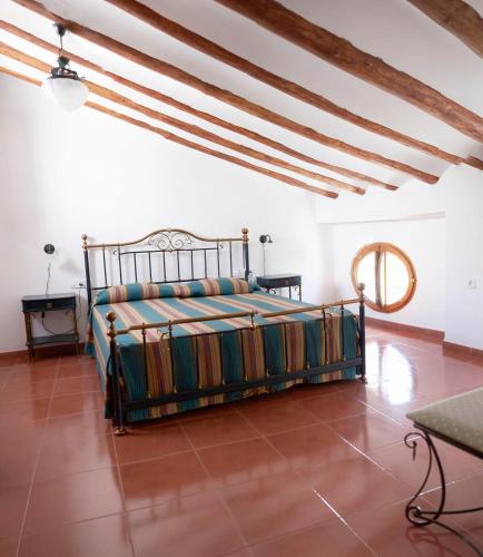 a bedroom with a bed in the middle of a room at Hotel Casa de los Arcos in Vélez Blanco
