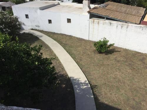 a concrete walkway in a yard next to a building at Casa Galletta in Stromboli