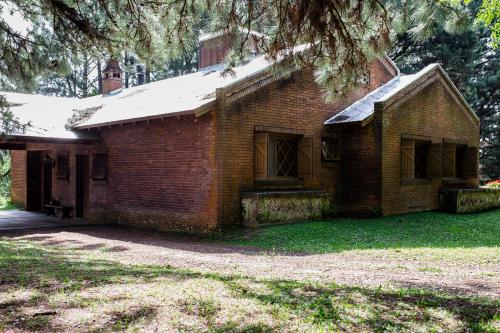 an old brick house with snow on the roof at OM B&B + Spa in Viamão