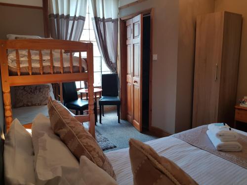 a bedroom with a bed and a bunk bed at Waterfront Hotel in Deal