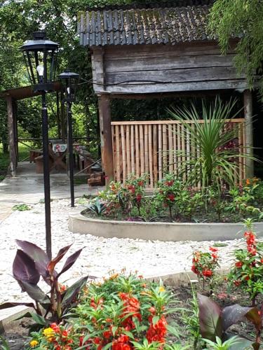 a garden with a pavilion with flowers and a street light at Guesthouse Luka in Martvili