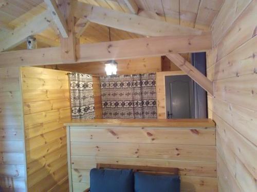 ビスカロッスにあるLa Grange et Le Nidの木製の壁が特徴のログキャビン内の客室です。