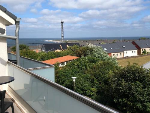 a balcony with a view of the ocean and houses at Tor zum Meer in Helgoland