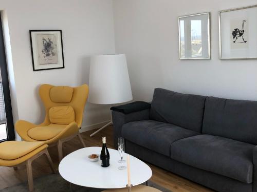 a living room with a couch and a table at Tor zum Meer in Helgoland