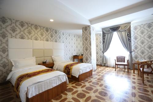 Ένα ή περισσότερα κρεβάτια σε δωμάτιο στο Baigal Hotel