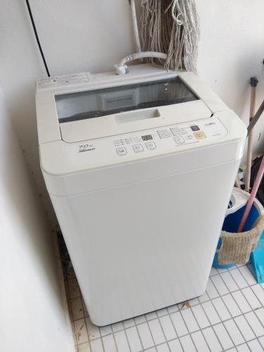 a washer and dryer sitting on a wall at Seri Lagenda Apartment in Kuah