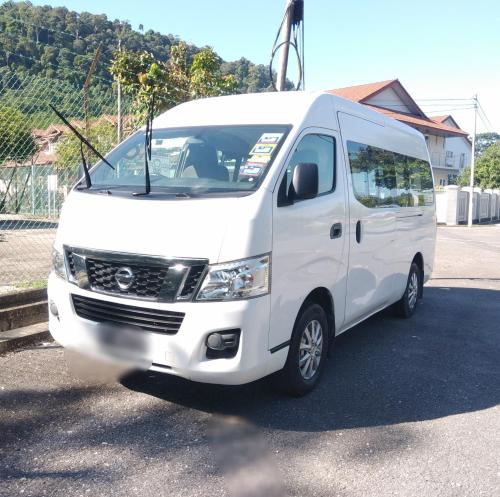 a white van parked in a parking lot at Seri Lagenda Apartment in Kuah