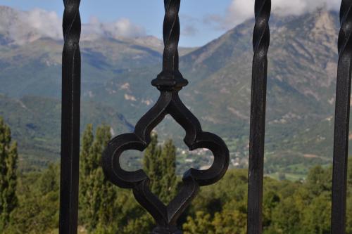 a iron fence with a view of mountains at Casa Rural Borda Marianet in Cerler