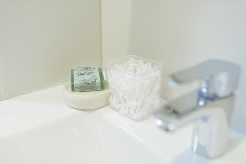 a bathroom counter with a bottle of soap and a sink at Apartment Luxury Explorer in Podgorica