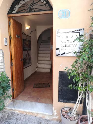an entrance to a building with a sign on the door at Casa Cinema Paradiso in Cefalù