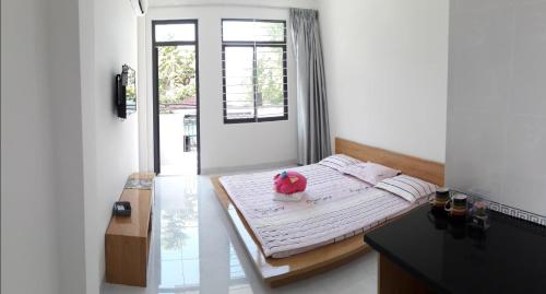 a bedroom with a bed with a pink pig on it at 91 Homestay, Cafe, Bonsai in Vung Tau