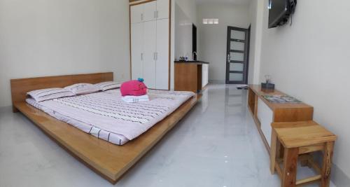 a bedroom with a bed with a pink hat on it at 91 Homestay, Cafe, Bonsai in Vung Tau