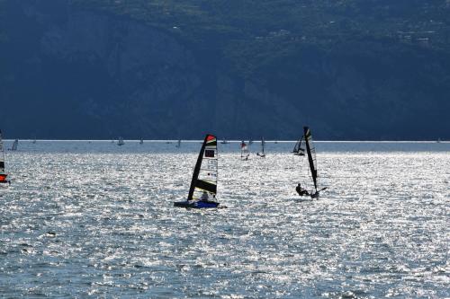a group of people windsurfing on a large body of water at Hotel Vela Azzurra in Malcesine