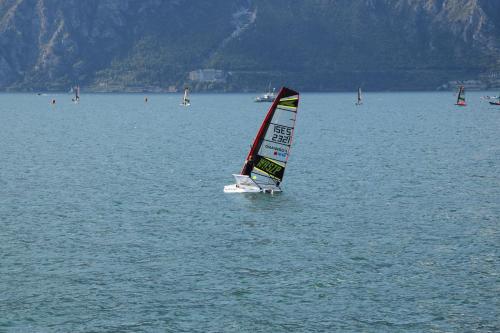 a small sail boat in a large body of water at Hotel Vela Azzurra in Malcesine