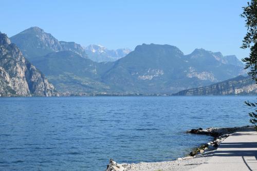 a view of a lake with mountains in the background at Hotel Vela Azzurra in Malcesine