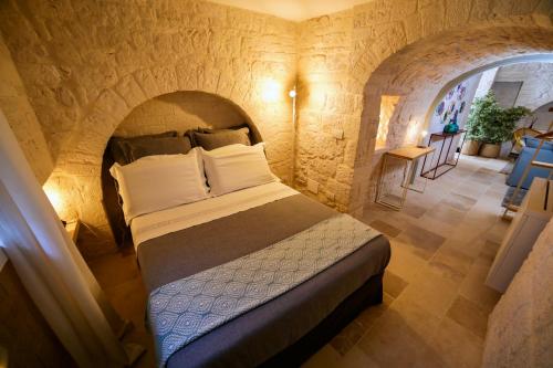 Postel nebo postele na pokoji v ubytování Hermanas Relais - trulli luxury