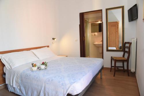 A bed or beds in a room at Albergo La Rosetta