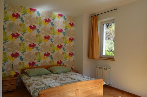 Säng eller sängar i ett rum på Luzik Krynica