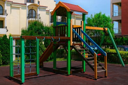 a playground with a slide in front of a building at Apart-Hotel Onegin & Thermal Zone in Sozopol
