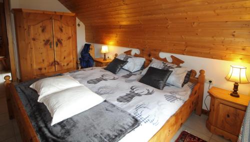 a bedroom with a large bed with wooden walls at Haus Franz by ISA AGENTUR in Bad Kleinkirchheim