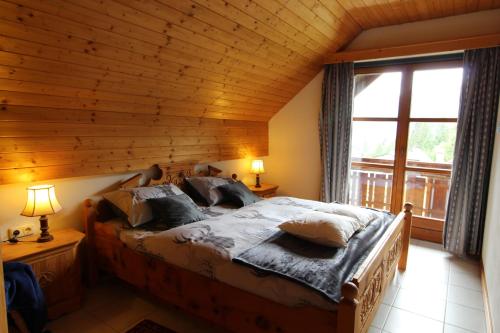 a bedroom with a large bed with a wooden ceiling at Haus Franz by ISA AGENTUR in Bad Kleinkirchheim