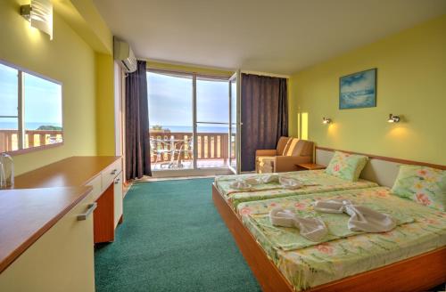 a hotel room with a bed and a balcony at Casa Di Angel in Sinemorets