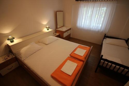a bedroom with a large bed with an orange tray on it at Apartman Anka in Novi Vinodolski