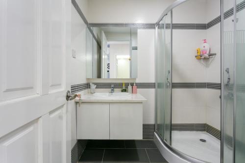 La salle de bains est pourvue d'un lavabo et d'une douche. dans l'établissement Sunrise City Trang' s Apartment W2-1704, à Hô-Chi-Minh-Ville