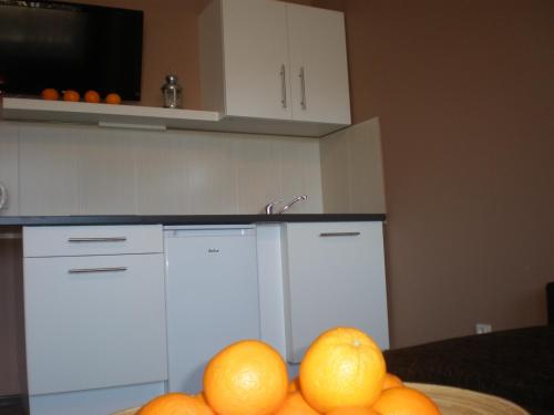 a bowl of oranges on a table in a kitchen at Apartamenty KopeX in Kostrzyn