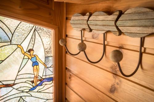 a stained glass door with a man on the window at Oustau Camarguen Hôtel & Spa in Le Grau-du-Roi