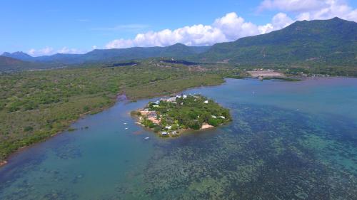 an island in the middle of a large body of water at La Cabane du Pecheur in Rivière Noire