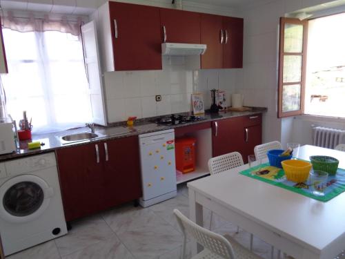 a kitchen with a sink and a washing machine at Casa Estrella in Pravia