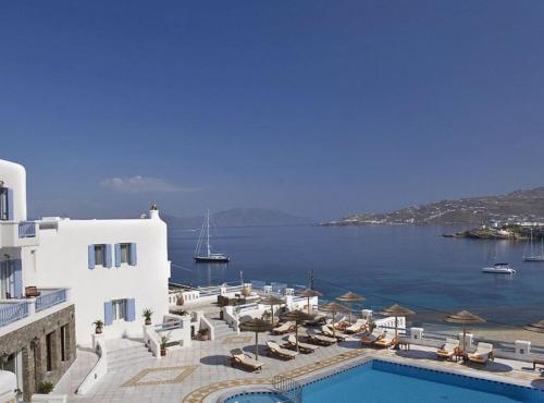 a resort with a swimming pool and a view of the water at Grand Beach Hotel in Mýkonos City