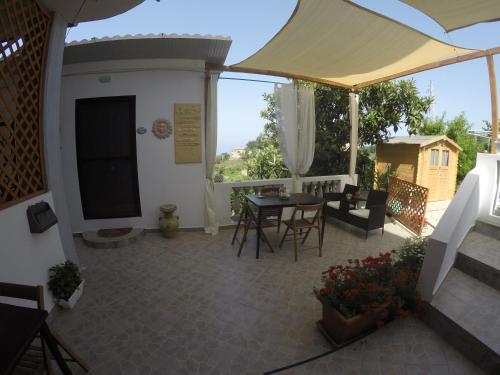 a view of a patio with a table and chairs at B&B Verzavò in Cetraro