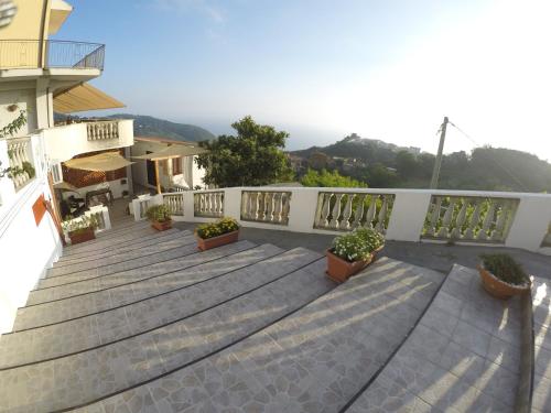 a balcony of a building with potted plants on it at B&B Verzavò in Cetraro