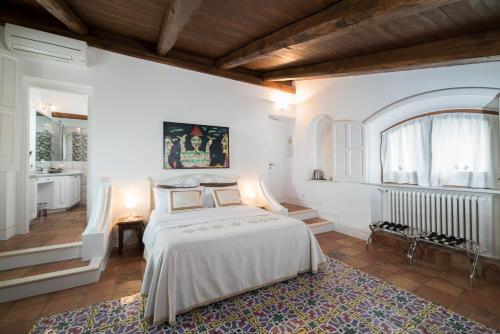 Ένα ή περισσότερα κρεβάτια σε δωμάτιο στο Palazzo Suriano Heritage Hotel
