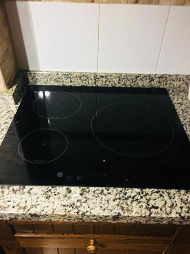 a black stove top oven sitting on top of a counter at Apartamento La Peatonal in San Sebastián de la Gomera