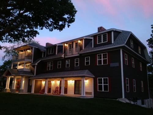a black house at night with its lights on at The Inn on Mount Desert in Bar Harbor