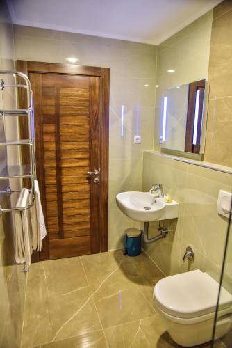a bathroom with a toilet and a sink at Hotel Prova in Ulcinj