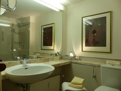 バート・ザルツフレンにあるResidenz am Kurparkのバスルーム(洗面台、トイレ、鏡付)
