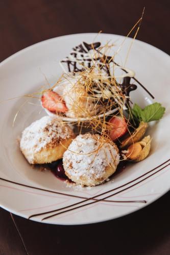 a white plate of food on a table at Strandhotel Sille in Reifnitz