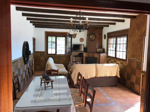 a living room with a table and a dining room at La Villa del Lago in Iznájar