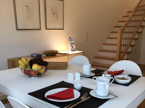 a dining room table with a bowl of fruit on it at Tor zum Meer in Helgoland