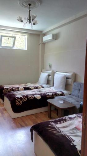 a living room with two beds and a couch at Sheki Guest House in Sheki