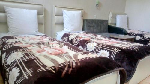 a hotel room with a bed and a chair at Sheki Guest House in Sheki