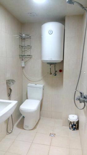 a bathroom with a toilet and a sink and a shower at Sheki Guest House in Sheki