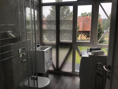 Et badeværelse på Vakarų apartamentai